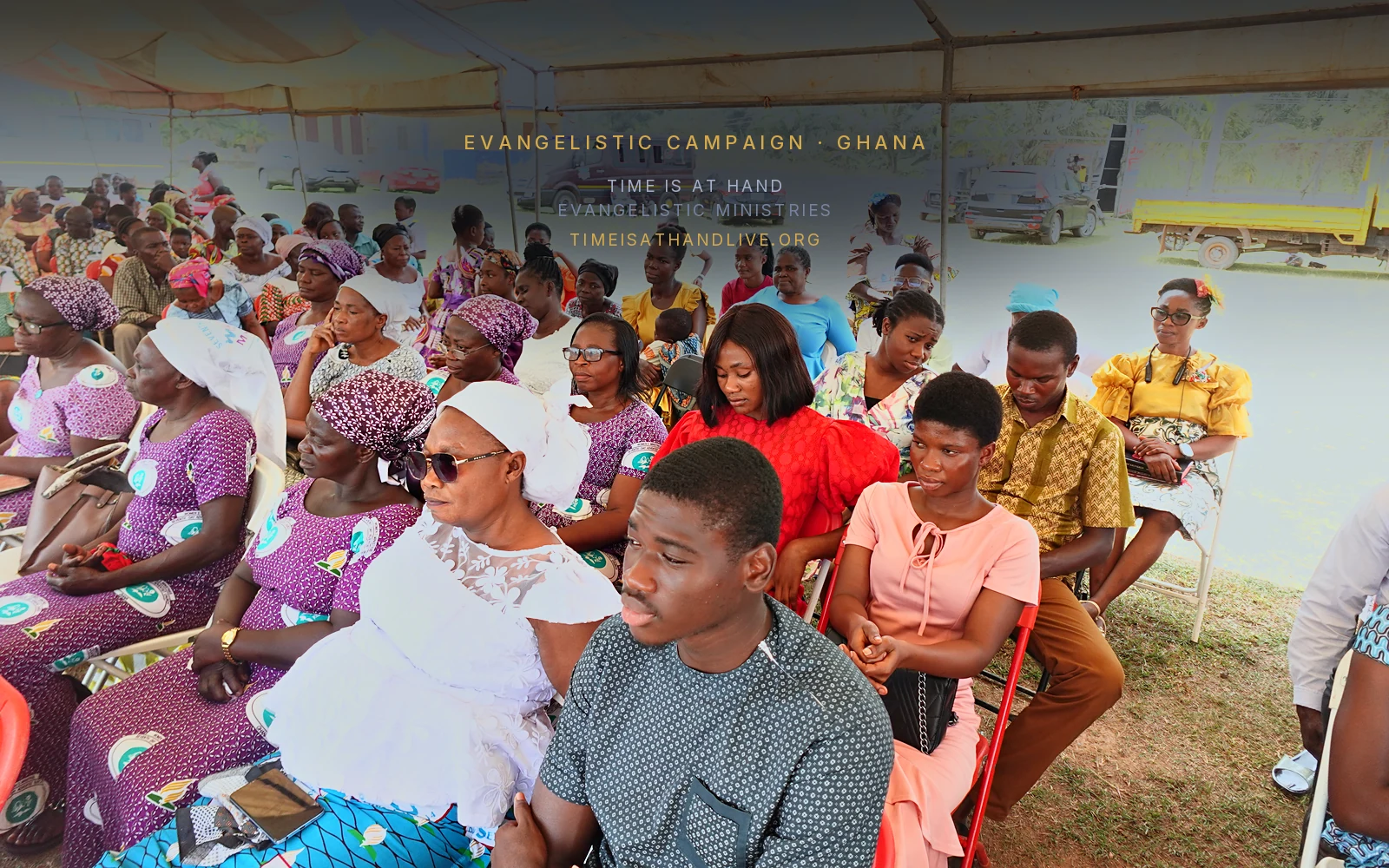 The congregation listening, many of the women in matching patterned dress