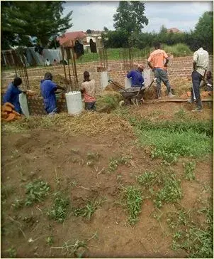 Volunteers building a church, laying blockwork on site