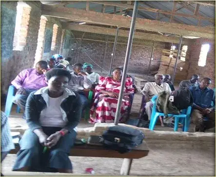 A congregation meeting under a temporary shelter before their church was built
