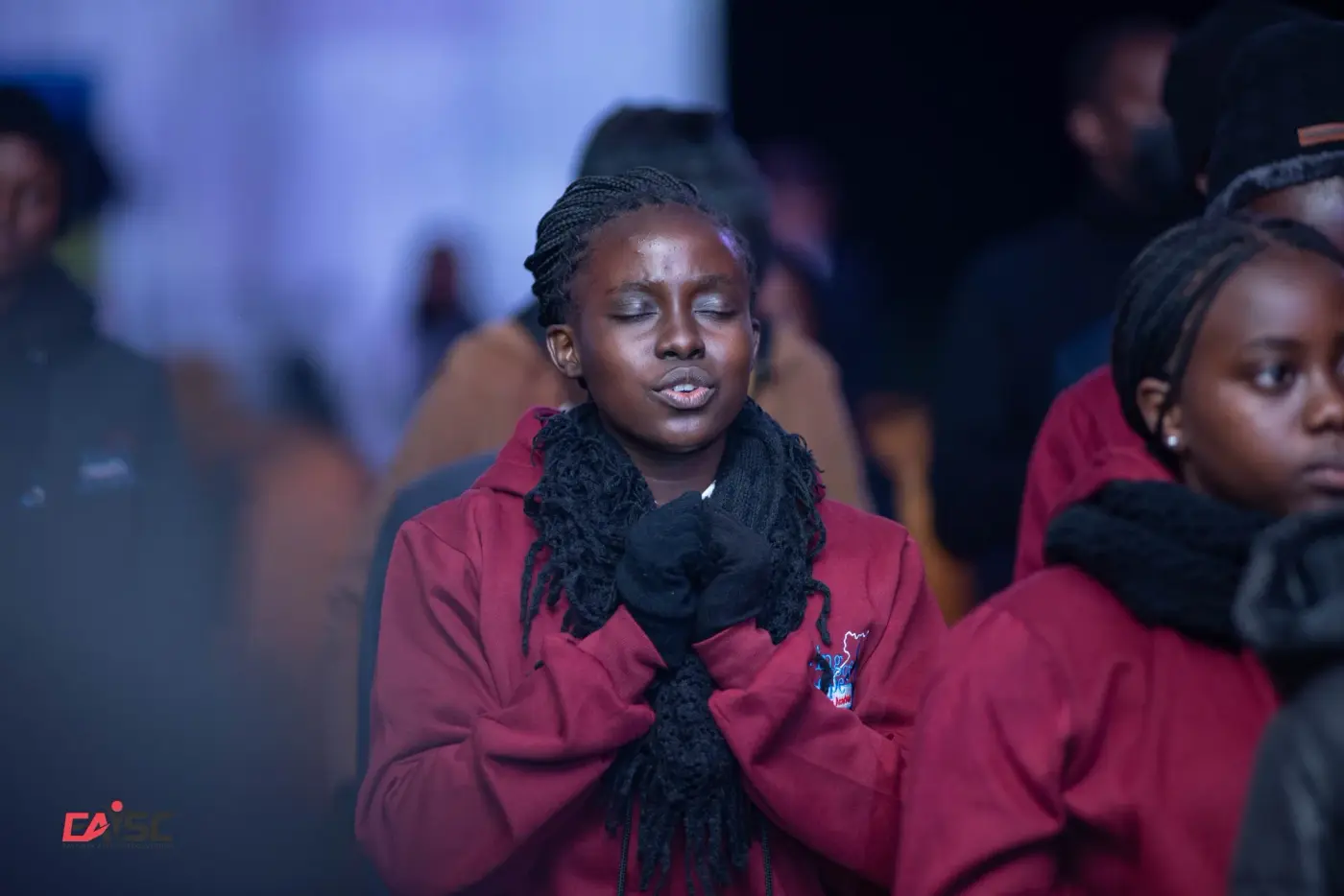 A woman in prayer during a Time Is At Hand meeting