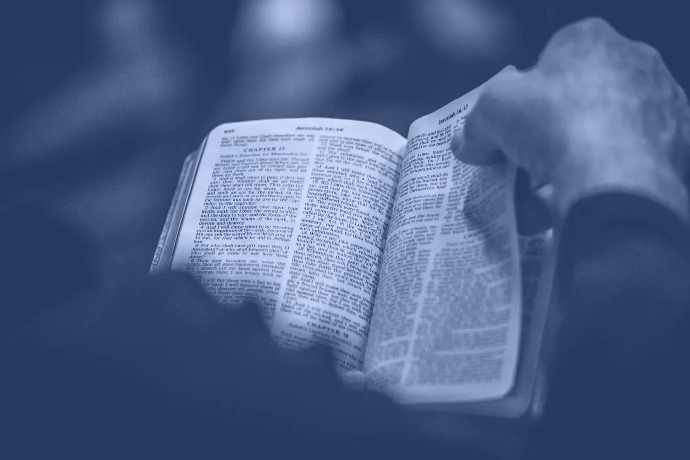 An open Bible held in cupped hands