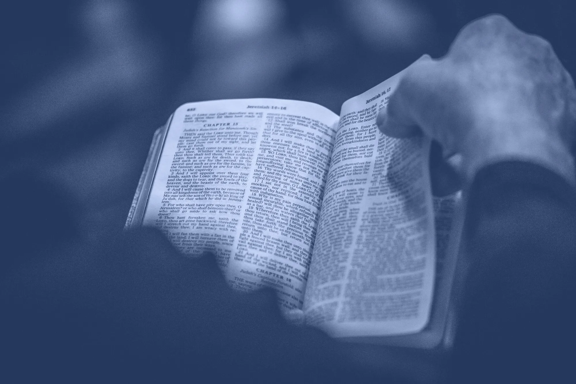 An open Bible held in cupped hands